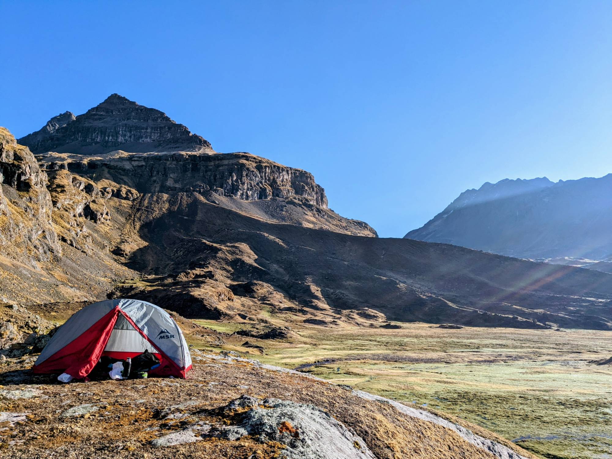 Camp for the night below the ridge, with the tent staked out on the rock.